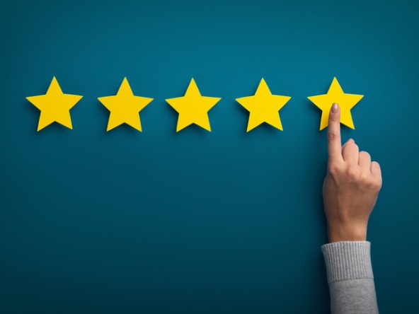 Five gold stars and a hand pointing 